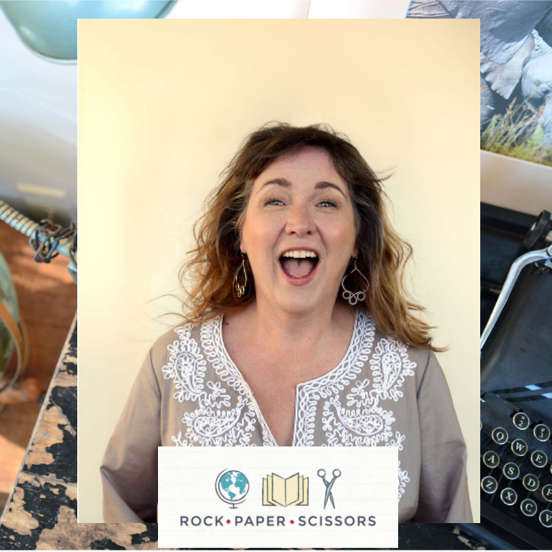 A woman laughing while holding a book, her secret weapon for joy and inspiration.